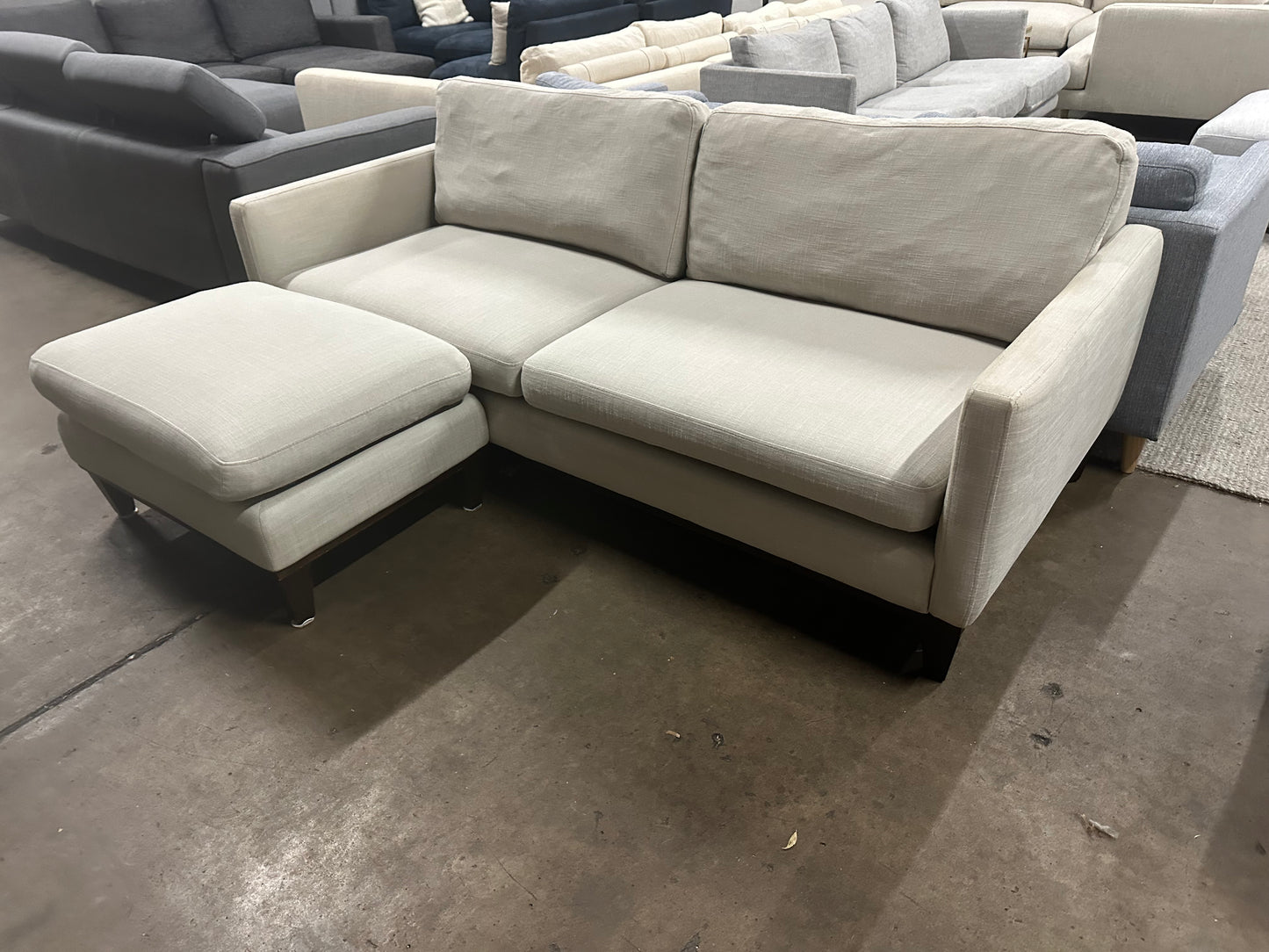 Affordable light grey color 2.5 seater and matching ottoman.