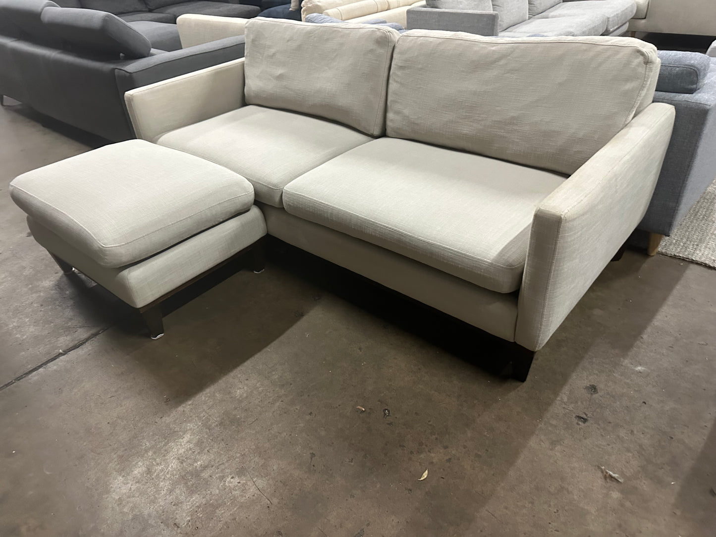 Affordable light grey color 2.5 seater and matching ottoman.