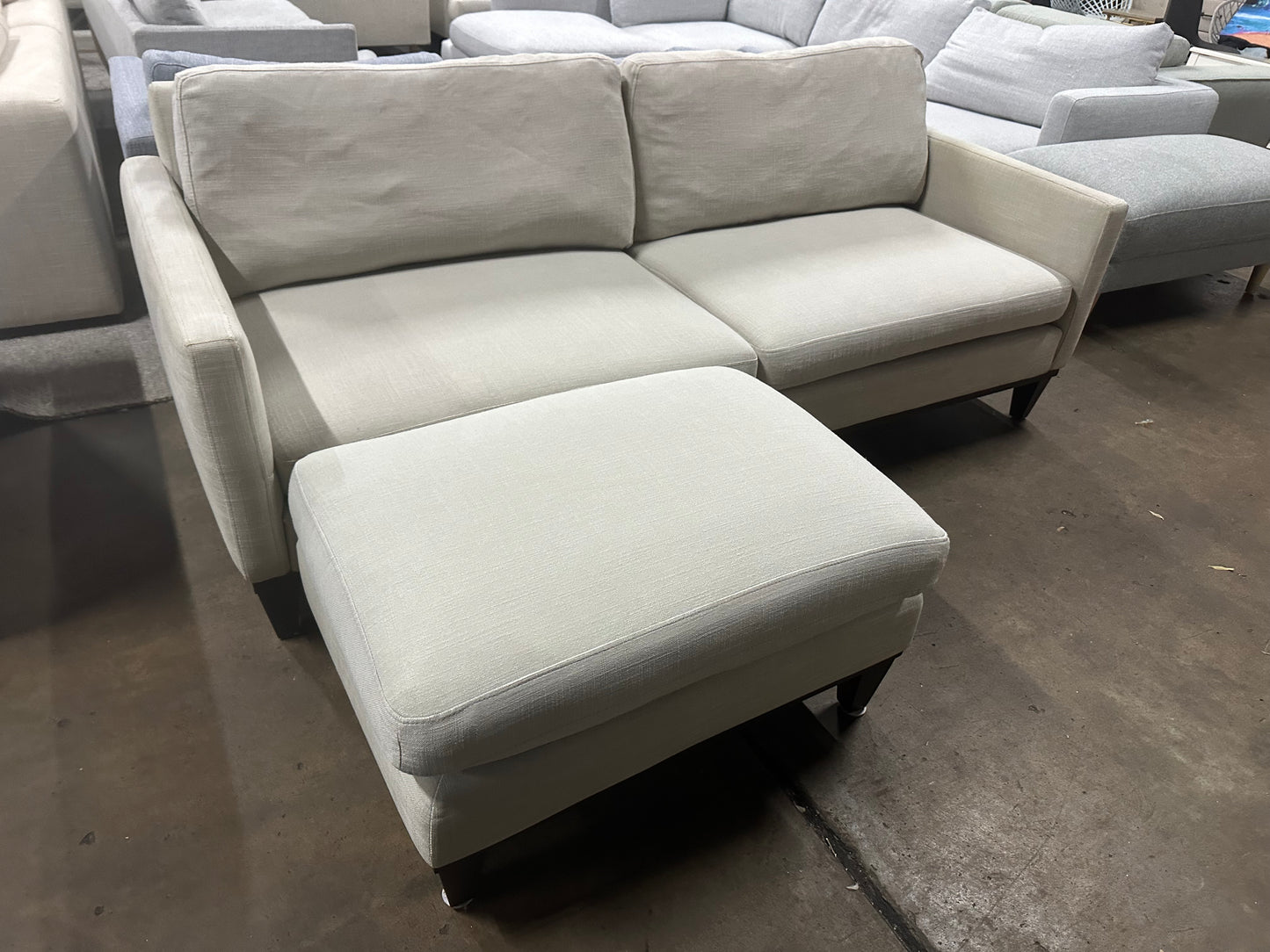 Affordable light grey color 2.5 seater and matching ottoman.
