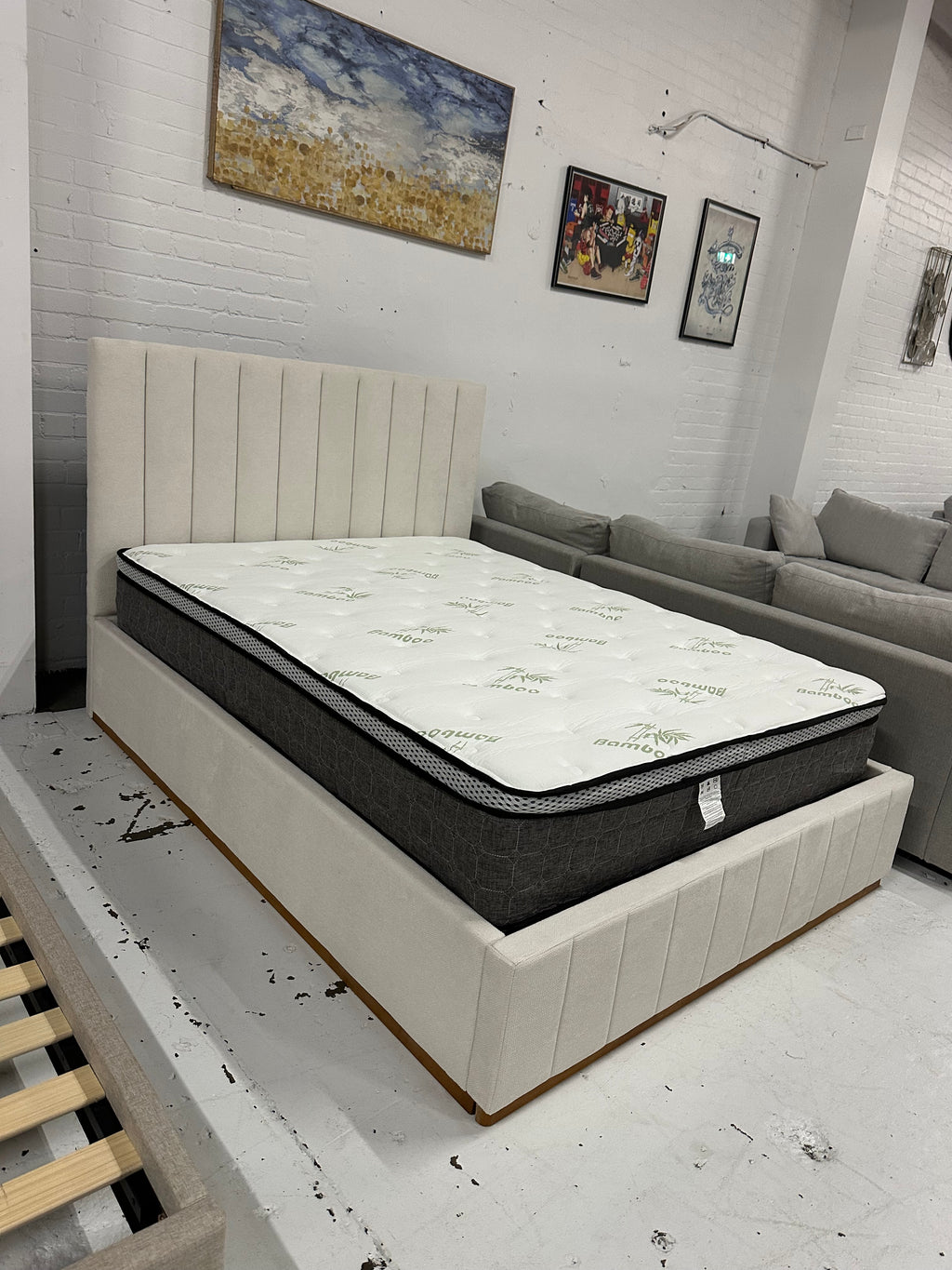 Cream color corduroy sofa and cream bed frame with mattress