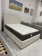 Cream color corduroy sofa and cream bed frame with mattress