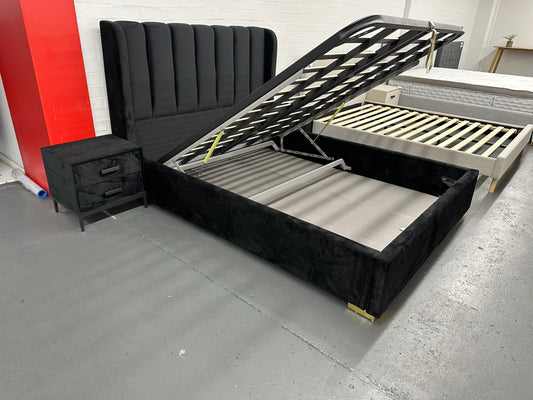 Solid queen bed frame with gaslift storage.