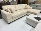 Cream color corduroy sofa and cream bed frame with mattress