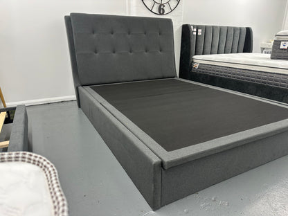 Solid queen bed frame with gaslift storage.