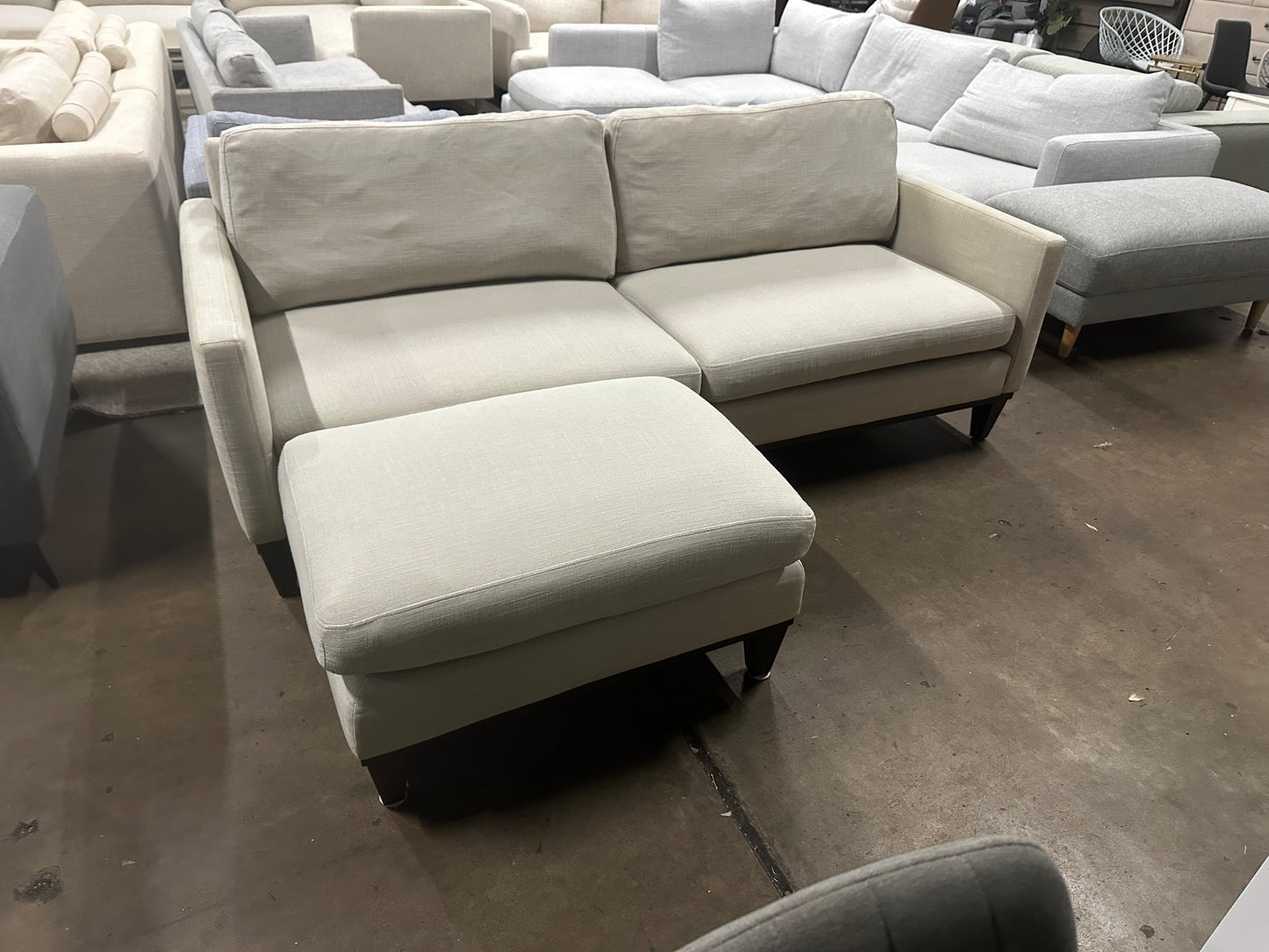 Affordable light grey color 2.5 seater and matching ottoman.