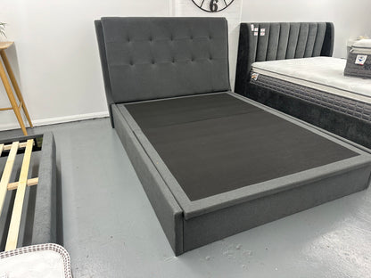 Solid queen bed frame with gaslift storage.