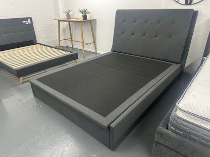 Solid upholstered grey bed frame with gaslift storage.