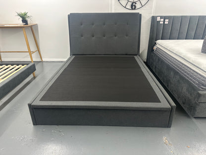 Solid upholstered grey bed frame with gaslift storage.