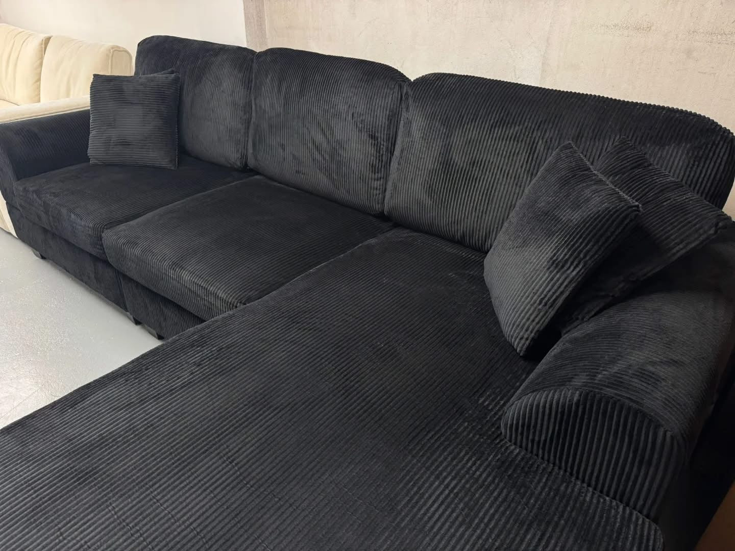 Noosa Corduroy Sofa. Black color reversible chaise.
