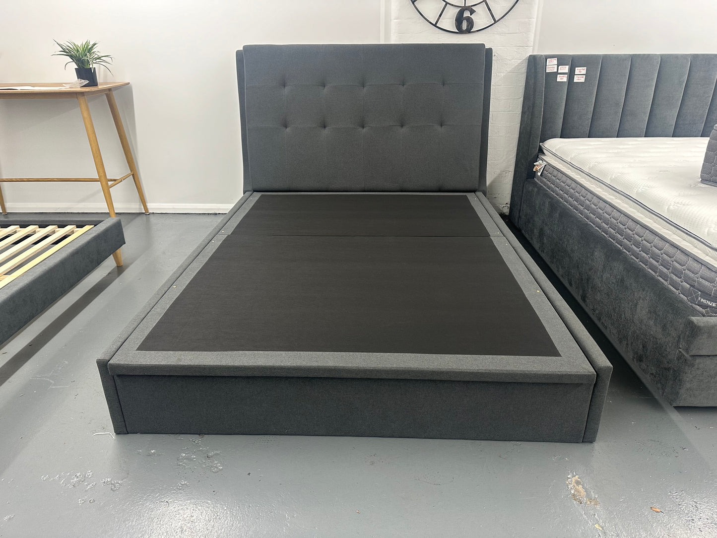 Solid queen bed frame with gaslift storage.