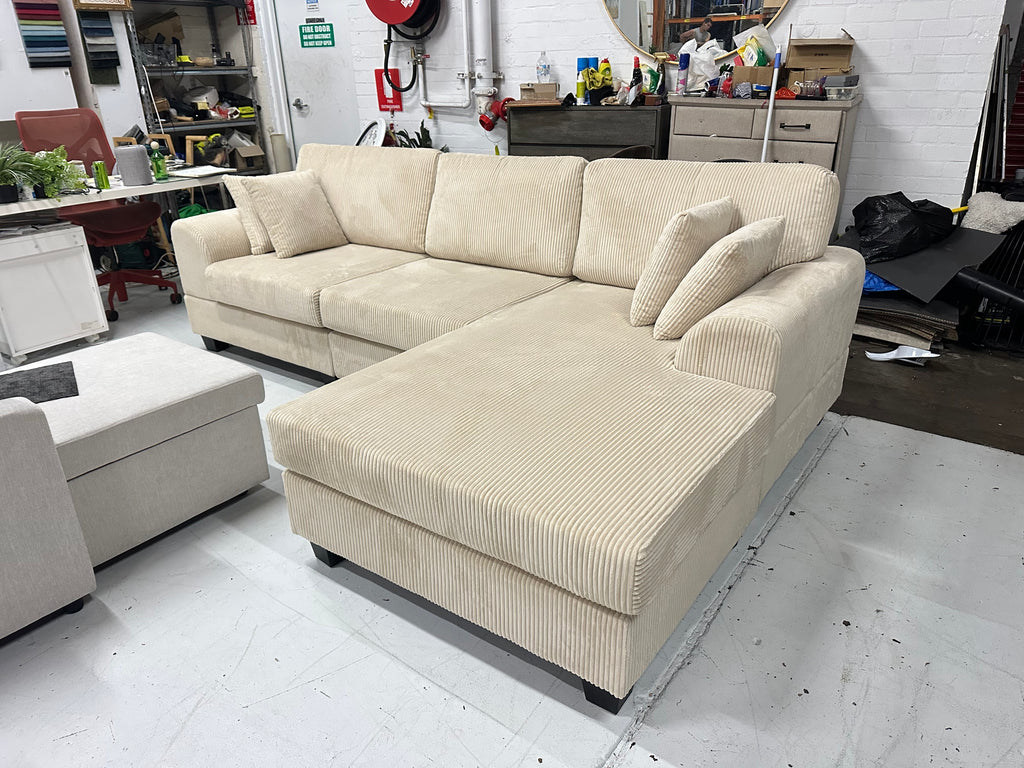 Cream color corduroy sofa and cream bed frame with mattress