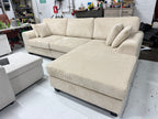 Cream color corduroy sofa and cream bed frame with mattress
